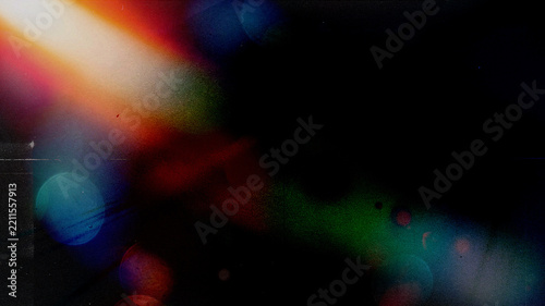 Light leak overlay, vintage film burn texture, abstract colorful lens flares and bokeh circles with dust and scratches on dark black grain background, retro analog film prism effects for designs and e
