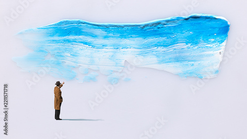 Man pointing at painted blue brushstroke in minimal collage with curious interest. Creative thinking, art education, new possibilities concept.