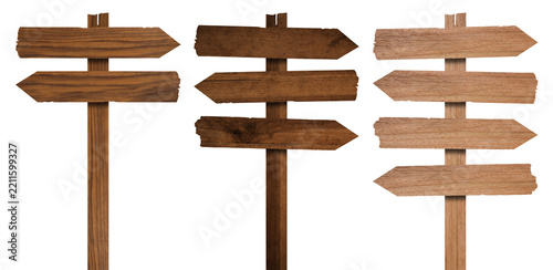 Wooden arrow signposts on metal pole with directional boards for rustic wayfinding and outdoor navigation. Trail markers with or pointer planks for parks and camping areas. Timber guidance system.