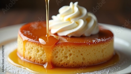 Slice of moist sponge cake topped with whipped cream and caramel sauce