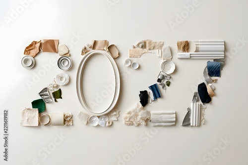Recycled materials shaped into large numbers on a clean neutral background for circular economy concept