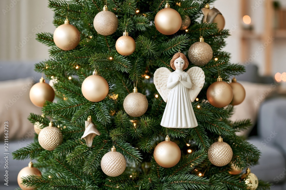 Obraz premium Christmas tree decorating with angel and golden baubles