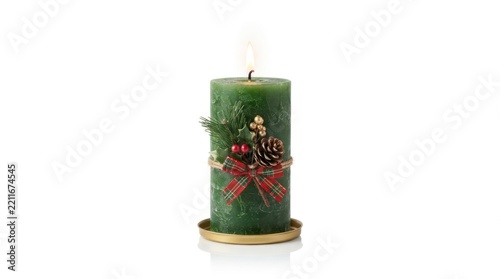 A green Christmas candle with pinecones and berries, lit and placed on a gold base against a white background.