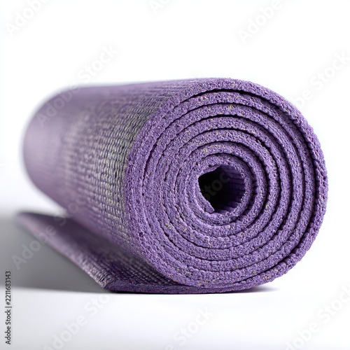 Rolled Purple Yoga Mat: A close-up, low-angle shot of a rolled purple yoga mat, showcasing its textured surface and spiral core.
