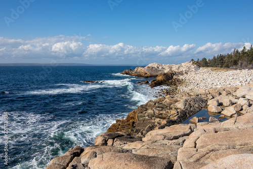 rugged granite and pebble coastal landscape that appears to be consistent with the shores of Herring Cove Provincial Park Reserve in Nova Scotia, Canada