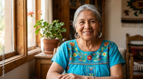 Smiling Hispanic Elderly Woman in Embroidered Shirt by Window - Authentic Portrait