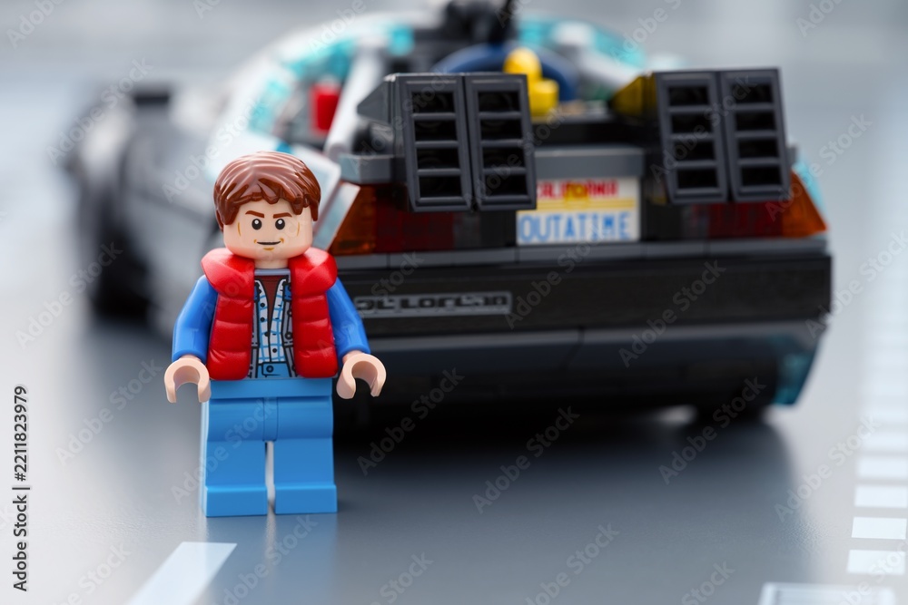 Obraz premium Tambov, Russian Federation - June 20, 2026 Lego Marty McFly minifigure standing near back of DeLorean time machine car from Back to the Future.