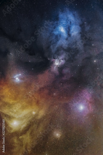 View of the colorful Rho Ophiuchi cloud complex featuring vibrant blue reflection nebulae, dark cosmic dust lanes, and glowing emission regions in the night sky of Poland.