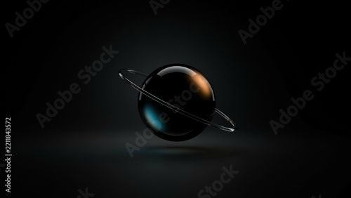 A dark glass sphere with a ring around it reflecting orange and blue light in a dark space
