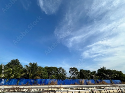 Sticker Beautiful blue sky with fluffy white clouds creating a peaceful natural background