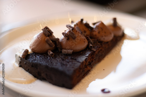 Obraz na plátně Rich chocolate cake topped with smooth chocolate mousse and delicate chocolate s