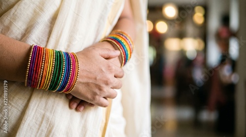 Woman wearing colorful rainbow bangles for pride celebration in sari