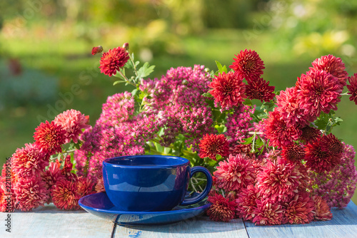 Afternoon tea in the blooming garden by sunny day