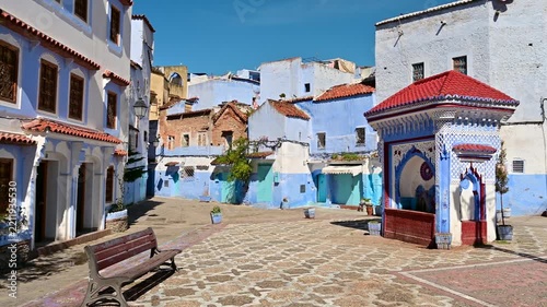 Blue painted buildings in a small Chefchaouen plaza