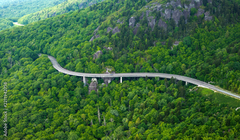 Obraz premium Blue Ridge Parkway road trip. Linn Cove Viaduct driving. Car exploration travel in summer forest on Appalachian mountain hills in North Carolina. Summertime landscape of beautiful nature
