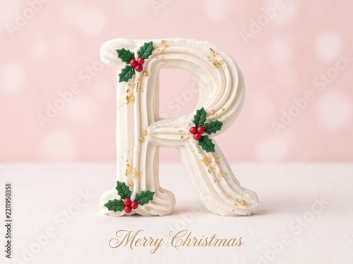Ornate white frosting letter R with holly pinecones gold stars and glitter Christmas decoration