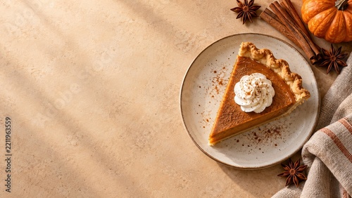 Pumpkin pie accents resting beside open space on a warm Thanksgiving background