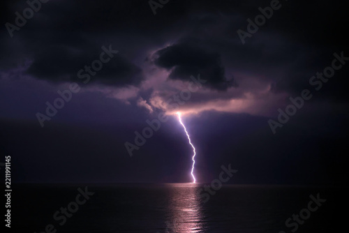 Lightning flashes and storm clouds over the sea