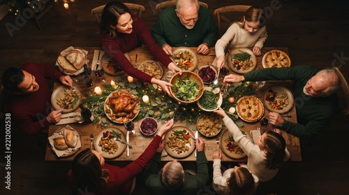 Festive, meal and people in home, reunion and celebration of Christmas with food at night or dinner. Above, group and family with feast for thanksgiving, evening and together on holiday in house