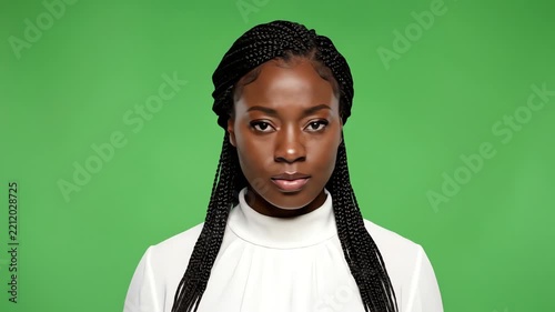 Young Black Woman with Braids, Serious Expression, Green Screen Background