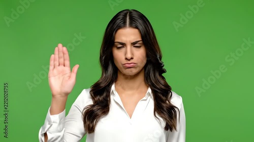 Young Woman with Serious Expression on Green Screen Background