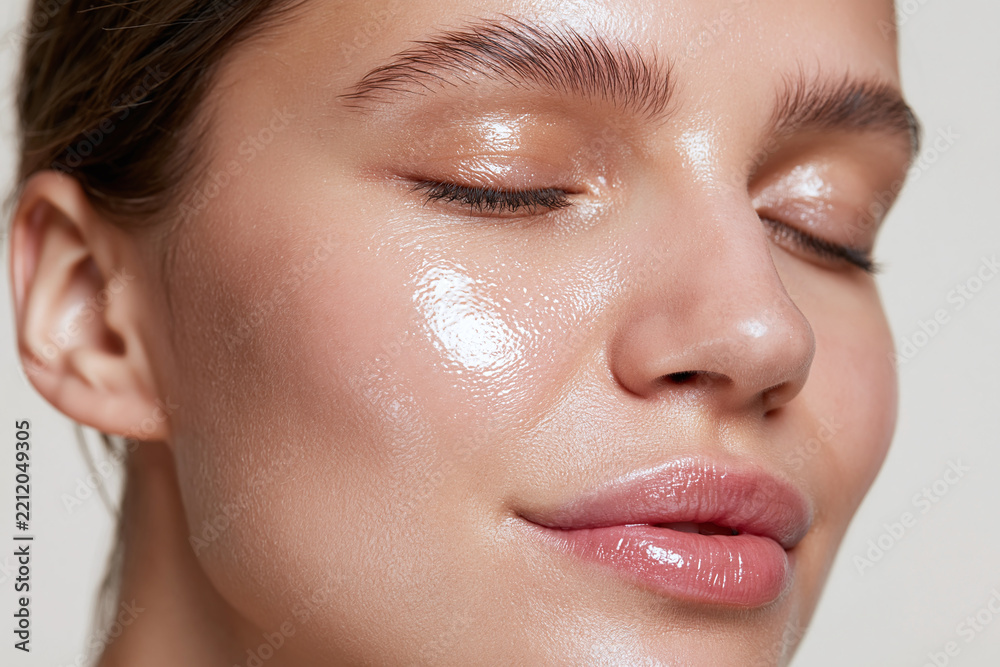 Obraz premium Dewy radiant skin close up glossy cheek and eyelid on young woman with smooth complexion and natural makeup conveying healthy glow and serenity