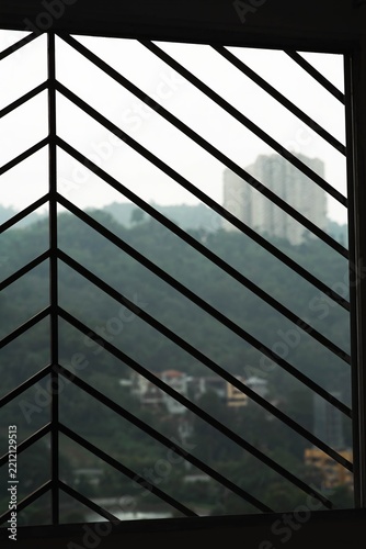 The present artifact is characterized by a contemporary abstract aesthetic, incorporating linear and striped motifs alongside the structural configuration of a window grille for ornamental purposes.