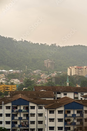 Keramat, Malaysia - July 6, 2022 Police housing in with the famous abandoned condominium Highland Tower in the background