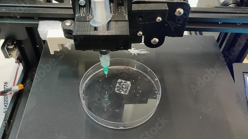 Bio 3D printer. A small bio 3D printer printed a small sample from hydrogel on a work surface. High-tech robotic device for layer-by-layer creation. New modern additive manufacturing. 3D printing