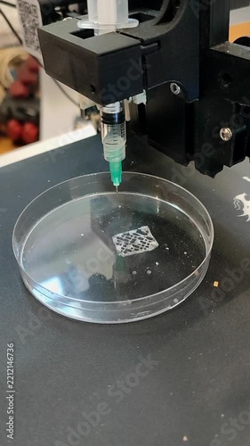 Bio 3D printer. A small bio 3D printer printed small sample from hydrogel on work surface. High-tech robotic device for layer-by-layer creation. New modern additive manufacturing. 3D printing Vertical