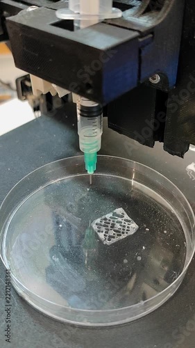 Bio 3D printer. A small bio 3D printer printed small sample from hydrogel on work surface. High-tech robotic device for layer-by-layer creation. New modern additive manufacturing. 3D printing Vertical