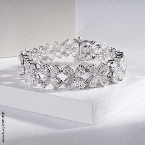 Designer diamond tennis bracelet with invisible setting, isolated on white background