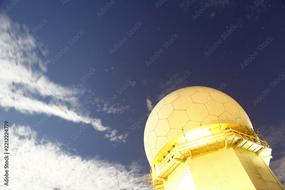 Fototapeta premium Radar dome glowing under starry night sky.