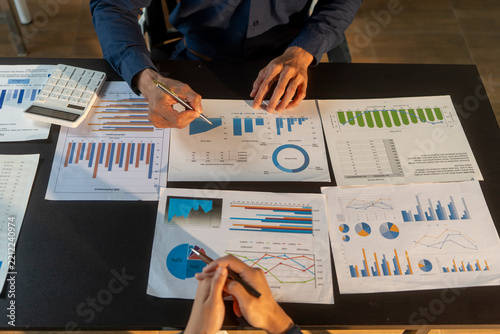Business people analyzing financial data and reports