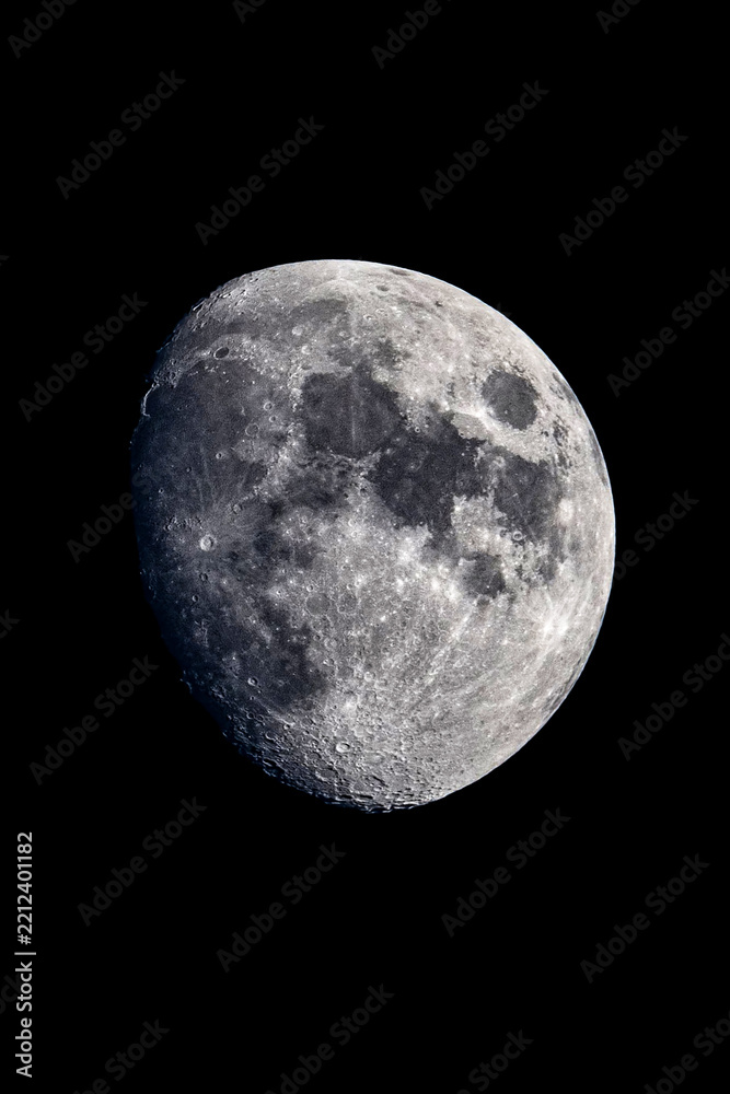 Fototapeta premium Detailed close-up photograph of the moon showcasing complex crater formations and maria against a stark black background.