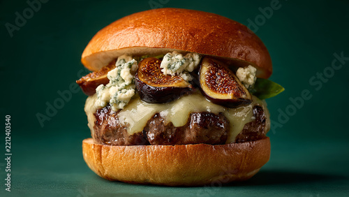 Upscale gourmet burger with figs and blue cheese, ideal for premium restaurant menus and fine dining promotions.