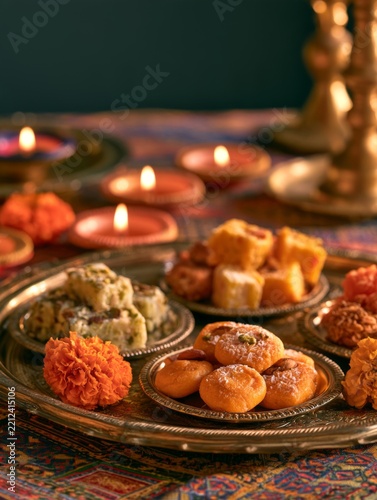 Colorful Indian Sweets Arranged on Decorative Tray for Diwali Celebration with Traditional Elements