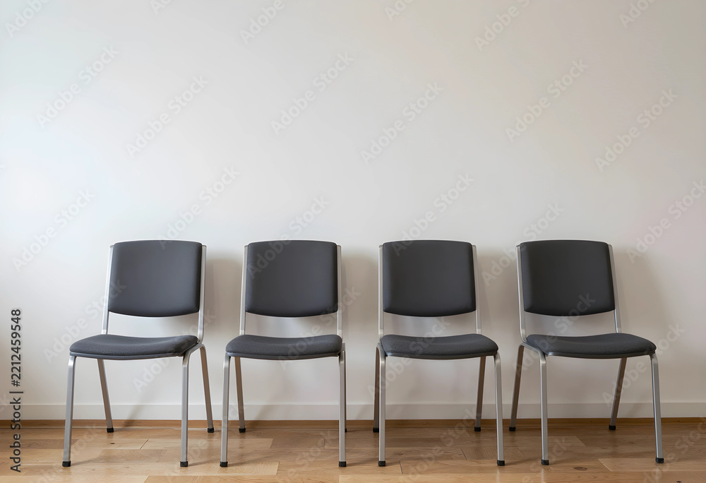 Obraz premium Unemployment and corporate downsizing, row of empty office chairs in a waiting room job loss and economic recession in the workplace