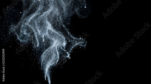 Elegant sparkling dust particles on black background for festive winter holiday designs