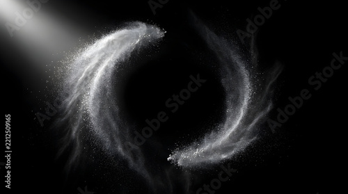 Elegant white powder swirl creating a festive abstract ring for holiday background design.