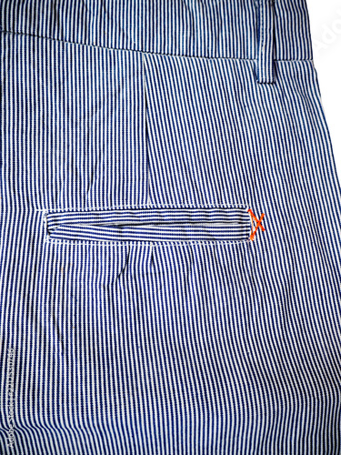 Blue men's trousers on a white background. Back side.