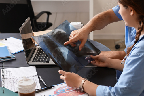 Medical diagnosis and healthcare collaboration, doctors analyzing chest x-ray...