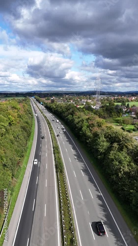 Aerial View of Highway Through Green Countryside with Power Lines