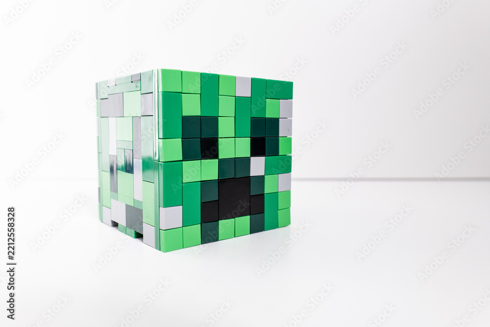 Naklejka premium A green Lego Minecraft creeper head shot isolated on a white background. Bradford, UK Oct 2 2026