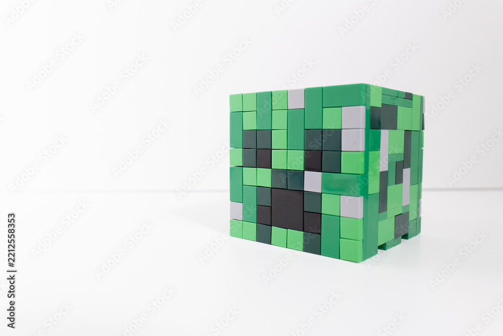 Naklejka premium A green Lego Minecraft creeper head shot isolated on a white background. Bradford, UK Oct 2 2026