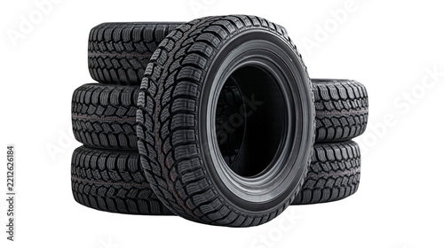 Stack of four black rubber winter car tires with deep tread patterns