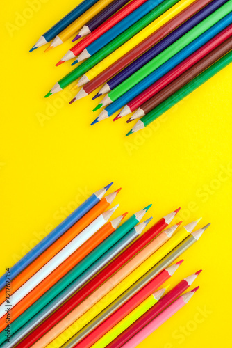 Colored pencils on a yellow background