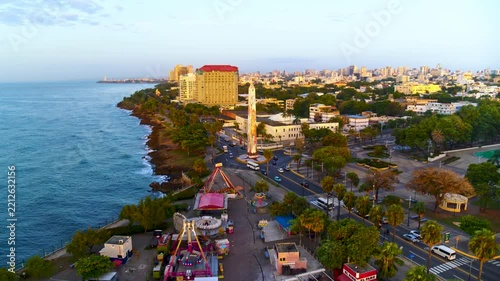 An urban amusement park on the coast of a seaside city. A fairground with rides. Summer, festival, celebration atmosphere. Santo Domingo, Dominican Republic – August 20, 2026.