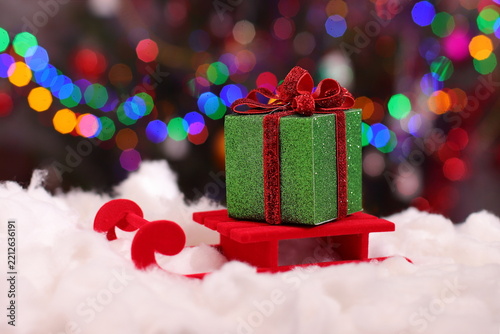 Christmas green present box, holiday package on snow