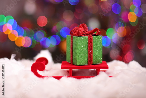 Christmas green present box, holiday package on snow
